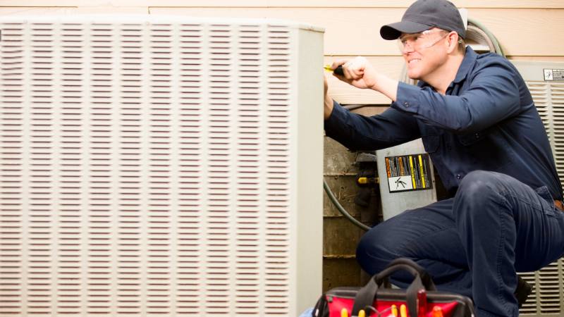 Hvac Technician Performing Maintenance On System